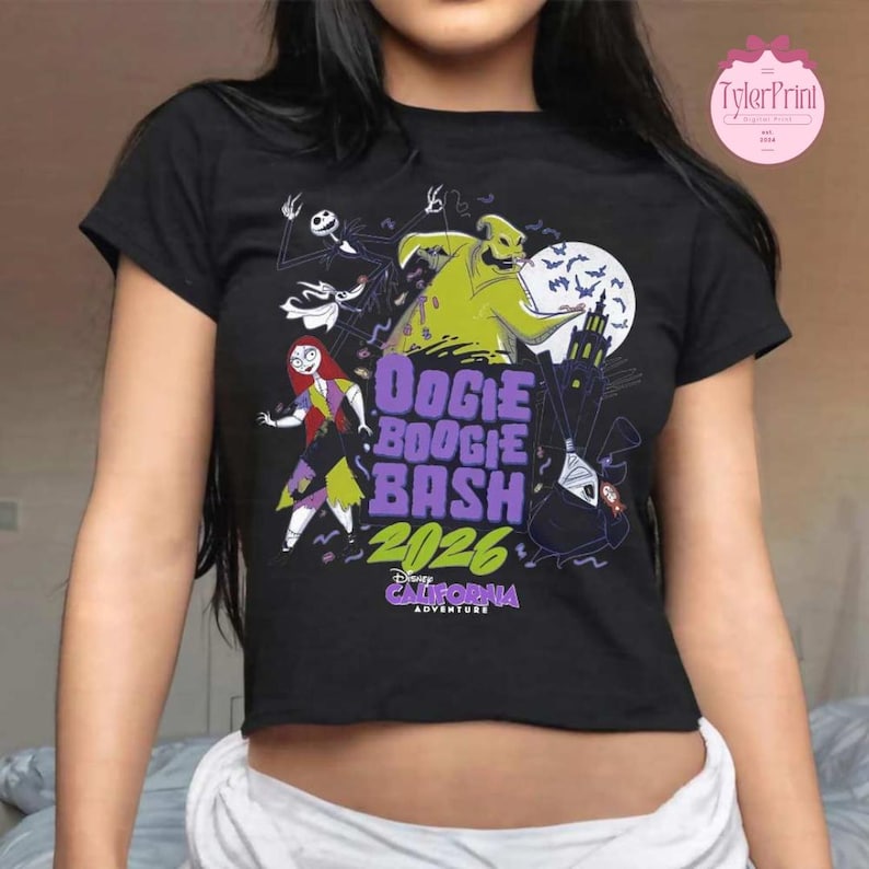 May include: A black short-sleeved t-shirt featuring a graphic print of characters from The Nightmare Before Christmas. The design includes the text Oogie Boogie Bash 2026 and Disney California Adventure in purple, green, and white ink colors.