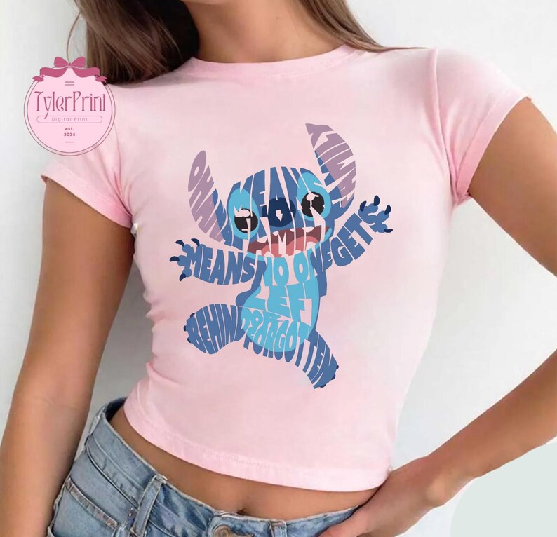 May include: Pink cropped t-shirt with a blue Stitch graphic made of text that says "Ohana means family and family means no one gets left behind or forgotten".