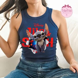 May include: Navy blue tank top with a graphic of Stitch from Disney's Lilo & Stitch, holding a red rose. The word "Disney" is above the character, and the words "Lilo & Stitch" are in red. The tank top is a sleeveless style.