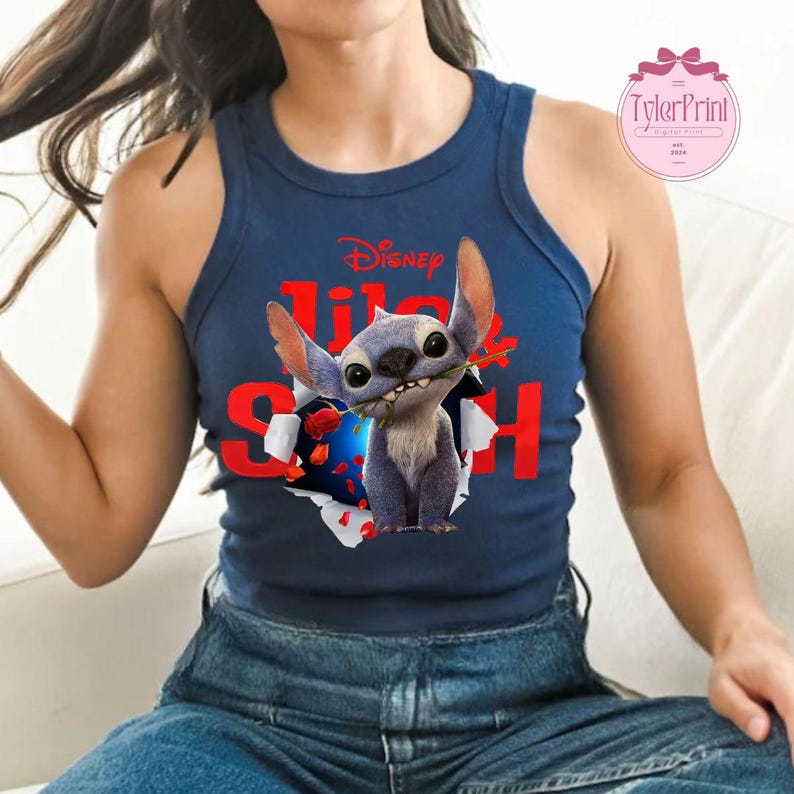 May include: Navy blue tank top with a graphic of Stitch from Disney's Lilo & Stitch, holding a red rose. The word "Disney" is above the character, and the words "Lilo & Stitch" are in red. The tank top is a sleeveless style.