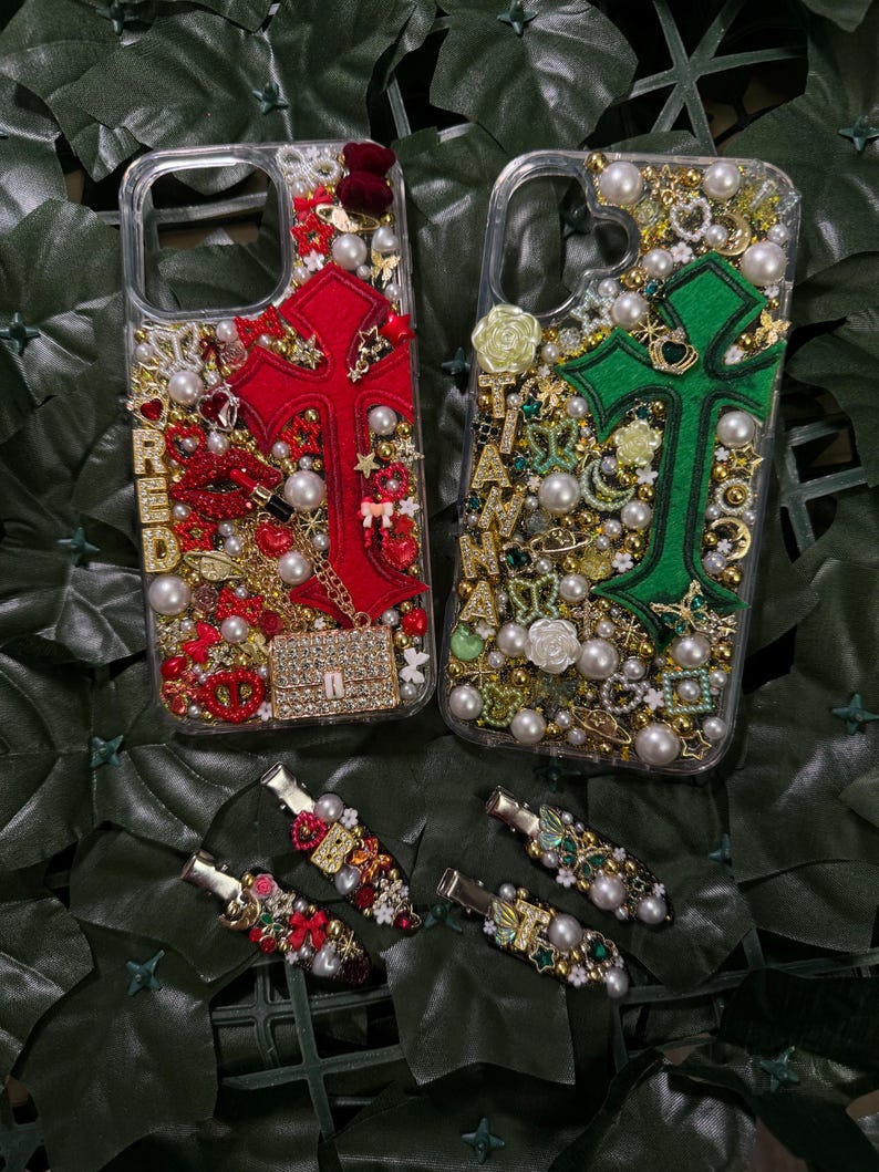 May include: Two clear phone cases decorated with rhinestones, pearls, and charms. One case features a red cross with the word "RED" and the other case features a green cross with the word "GREEN".