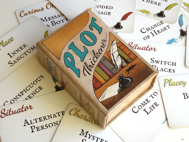 May include: A rectangular card game box titled Plot Thickener with an illustration of a quill pen in an inkwell and colorful books. The box is surrounded by white playing cards featuring text such as Inner Sanctum, Switch Places, and Come to Life.