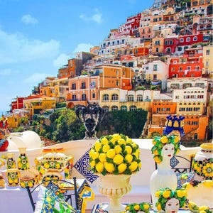 May include: A vibrant display of ceramic art and decorative items, including vases, bowls, and head sculptures, with a lemon theme. The background features a colorful hillside town under a clear blue sky.