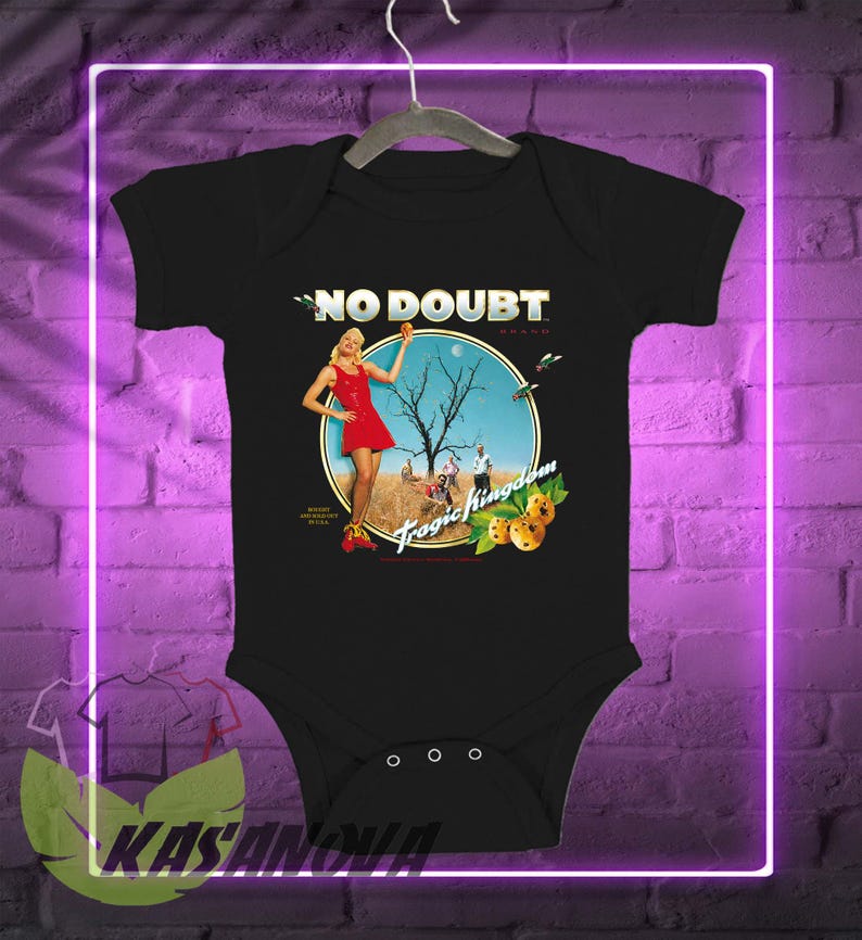 May include: Black baby bodysuit featuring the words "NO DOUBT" above a circular graphic. The graphic depicts a woman in a red dress, a barren tree, and the words "Tragic Kingdom". The bodysuit has three snaps at the bottom.