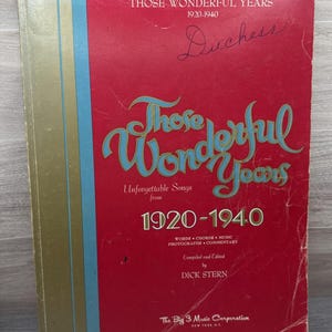 May include: A vintage music book titled "Those Wonderful Years 1920-1940" with a red cover. The cover features the title in large, turquoise script, and the name "Duchess" is handwritten. The book is compiled and edited by Dick Stern.