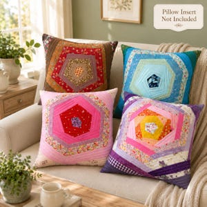 May include: Four square throw pillows featuring a geometric log cabin quilt pattern with concentric hexagonal layers in red, blue, pink, and purple color palettes. Each pillow displays a central floral or patterned fabric patch. Pillow insert not included.