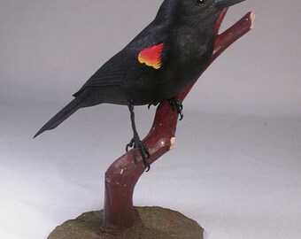 Red-winged Blackbird Wooden carved Bird on wooden carved branch