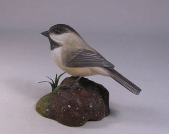 Black-capped Chickadee on carved wooden base