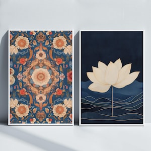 May include: Two framed prints with floral designs. The first print features a blue background with a symmetrical pattern of orange, red, and white flowers. The second print features a dark blue background with a white lotus flower and gold lines.