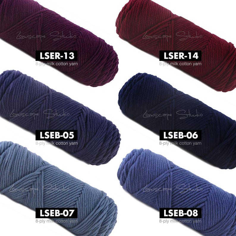 May include: A collection of six skeins of 8-ply milk cotton yarn in various shades of purple, burgundy, and blue. Each skein is labeled with a unique code and the brand name. The yarn is tightly wound, suggesting it's suitable for knitting or crochet projects.