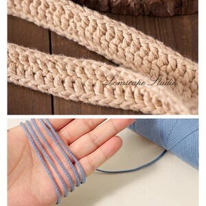 May include: Close-up of two beige knitted straps and blue yarn. The straps are thick and textured, with a woven pattern. The blue yarn is thin and appears to be made of multiple strands. The text "Lomscape Studio" is visible on the straps.