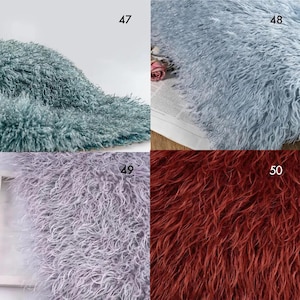 May include: A collage of four swatches of long-pile faux fur fabric. Number 47 is teal, number 48 is light blue, number 49 is lavender, and number 50 is a deep rust red. Each section displays the dense, curly, and shaggy texture of the material.