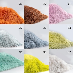 May include: A grid of nine swatches of shaggy, long-pile faux fur fabric in various colors, labeled with numbers 29 through 37. The colors include orange, brown, light purple, light gray, blue-gray, lime green, mint green, yellow, and white.