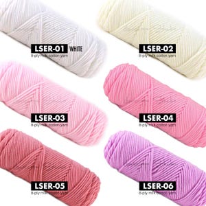 May include: Six skeins of 8-ply milk cotton yarn in various colors. The colors include white, cream, light pink, medium pink, rose, and lavender. Each skein is labeled with a product code and the yarn type.