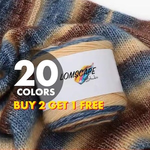 May include: A ball of yarn with a label displaying "Lomscape Studio." The yarn is a mix of blue, brown, and beige hues. The image also shows the text "20 COLORS" and "BUY 2 GET 1 FREE."
