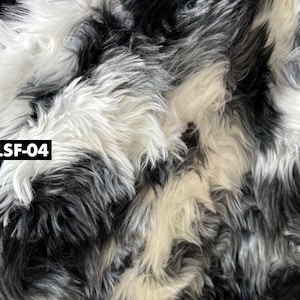 May include: Close-up of a faux fur fabric with a mix of black, white, and gray fibers. The fabric has a shaggy texture and a dense pile. The text "LSF-04" is in a black rectangle in the lower left corner.