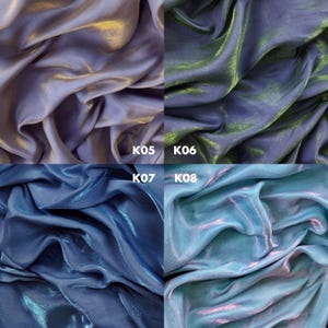May include: A grid of four fabric swatches with a shimmering, iridescent finish. Top left K05 is light purple, top right K06 is dark blue with green highlights, bottom left K07 is medium blue, and bottom right K08 is light blue with pink tones.