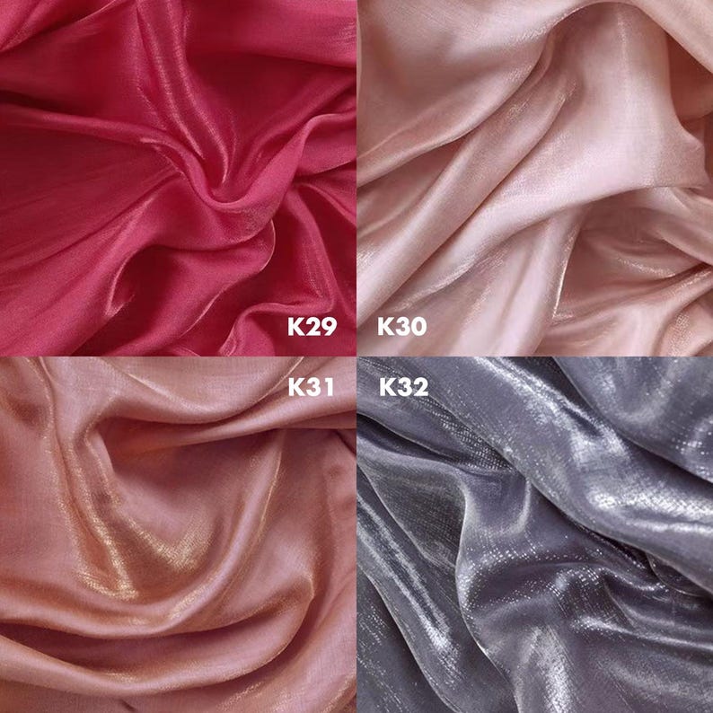 May include: A grid of four fabric swatches with a shimmering, metallic finish. The top left is deep magenta labeled K29, top right is pale blush pink labeled K30, bottom left is warm copper labeled K31, and bottom right is cool silver labeled K32.