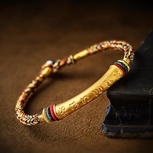 EverestArtStudios 1 gram 999 Fine Gold Six Syllable Mantra Cord Bracelet, Large 38 mm Tube, Red Black or Multicolour Buddhist Wrist Bracelet