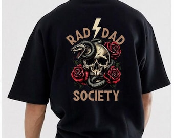 May include: Black t-shirt with a graphic design featuring a skull, a snake, and red roses. The text "RAD DAD SOCIETY" is printed above and below the skull, with a lightning bolt graphic.