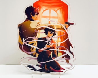 May include: An acrylic stand featuring two anime characters. The character on the left is wearing a white coat and has brown hair. The character on the right is wearing a black suit and has black hair. The background is a red curtain with a window behind them.