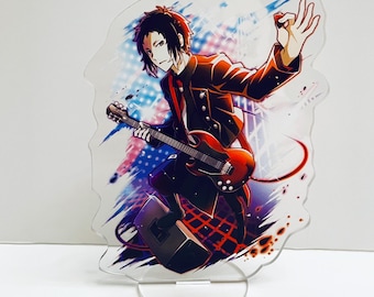 May include: An acrylic stand featuring an anime character playing a red electric guitar with a black and white background. The character is wearing a black suit with a red tie and has black hair.