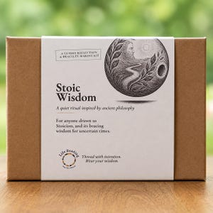 May include: A rectangular brown cardboard box with a white paper sleeve featuring the text Stoic Wisdom, A guided reflection & bracelet-making kit, A quiet ritual inspired by ancient philosophy, and a circular black and white illustration.