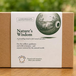 May include: A rectangular brown cardboard box with a white paper sleeve featuring the text Nature's Wisdom, A guided reflection & bracelet-making kit, A grounding ritual to feel rooted and alive, and an illustration of a green landscape inside a sphere.