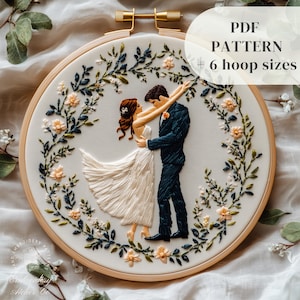 May include: Embroidered hoop art depicting a dancing couple, framed by floral embroidery. The design shows a bride in a white dress and a groom in a navy suit. Text on the image reads "PDF PATTERN + 6 hoop sizes".