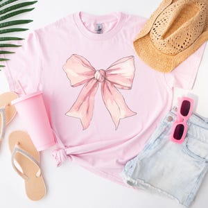 Cute Pink Coquette Bow T-Shirt for Women and Girls, Stylish Pink Bow Graphic Tee, Feminine and Trendy Casual Shirt