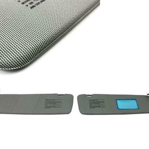 May include: Two gray car sun visors, one with a blue tinted section. The visors have a rectangular shape and are designed to block sunlight. The top of the image shows a section of a gray and white patterned material.