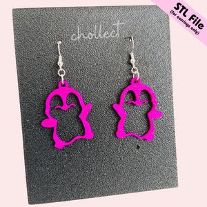 May include: A pair of vibrant pink penguin earrings with silver hooks. The earrings are presented on a dark grey textured surface. The text "STL File (for earrings only)" is in the upper right corner.