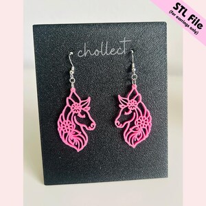 May include: A pair of pink unicorn earrings with intricate floral designs. The earrings are on a black card with the word "cholleect" written on it. STL File (for earrings only).