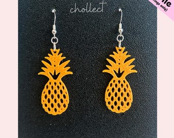 May include: Two yellow pineapple earrings with silver hooks. The earrings are made of a textured material and have a detailed design. The word "chollect" is written in cursive. The text "STL File (for earrings only)" is in the upper right corner.