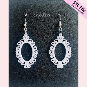 May include: A pair of white, ornate oval-shaped earrings with a decorative filigree design. The earrings are suspended from silver-colored hooks. The text "chollect" is written in cursive. The text "STL File (for earrings only)" is also visible.