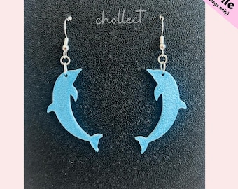 May include: Light blue dolphin earrings with silver hooks, displayed against a black backdrop. The word "chollect" is written in cursive. The text "STL File (for earrings only)" is in the upper right corner. A pair of earrings.
