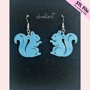 May include: A pair of light blue squirrel-shaped earrings with silver-colored hooks. The earrings are displayed against a black background with the word "chollect" in cursive. The top right corner has the text "STL File (for earrings only)".