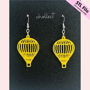 May include: A pair of yellow hot air balloon earrings with silver hooks. The earrings are made of a lightweight material and feature a detailed cage design. The background is black with the word "chollect" in cursive and the text "STL File (for earrings only)".