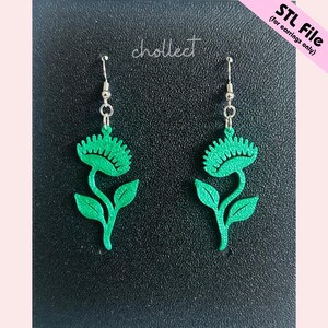 May include: Green, plant-shaped earrings with a Venus flytrap design, suspended from silver hooks. The earrings feature the word "chollect" in cursive. The text "STL File (for earrings only)" is in the upper right corner.