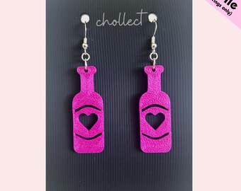 May include: A pair of magenta earrings shaped like wine bottles, each with a heart cutout. The earrings hang from silver-colored hooks. The background is a black card with the word "chollect" and the text "STL File (for earrings only)".