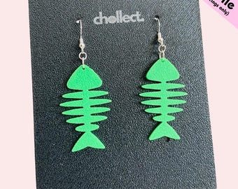 May include: A pair of green fishbone earrings with silver hooks. The earrings are presented on a black surface, with the text "chellect" and "STL File (for earrings only)".