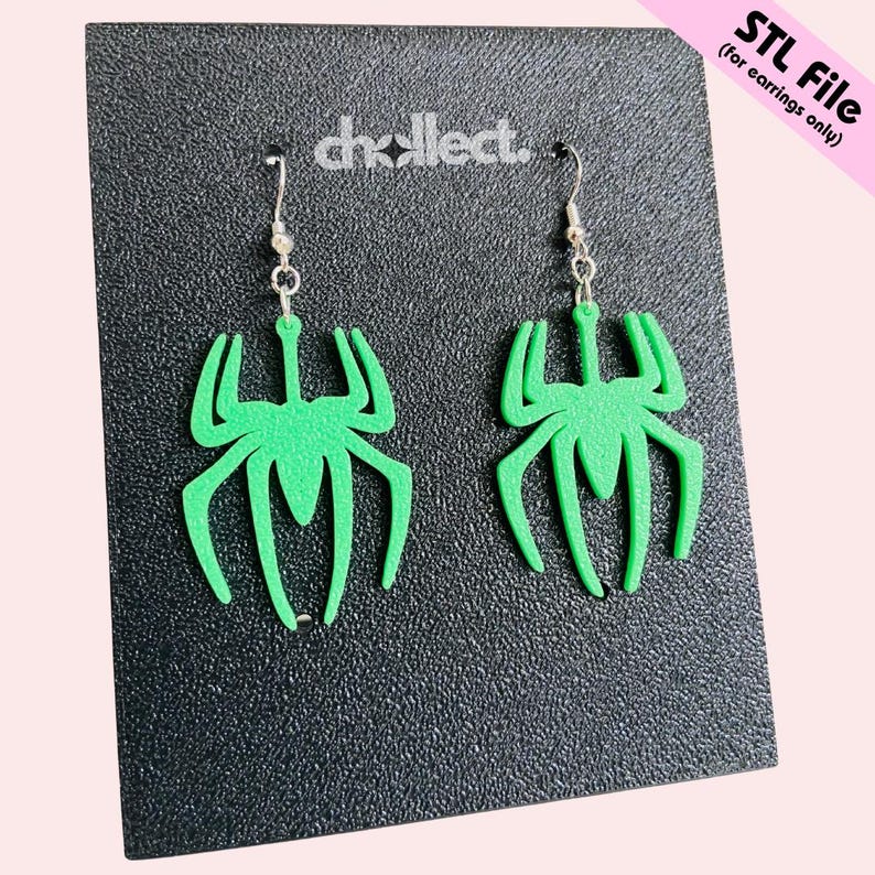May include: A pair of green spider-shaped earrings with silver-colored hooks. The earrings are displayed on a black textured surface. The text "STL File (for earrings only)" is in the upper right corner.