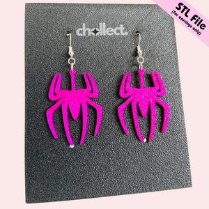May include: A pair of hot pink spider-shaped earrings with silver-colored hooks. The earrings are displayed on a black surface with the text "STL File (for earrings only)" in the upper right corner. The brand name "chcollect" is also visible.