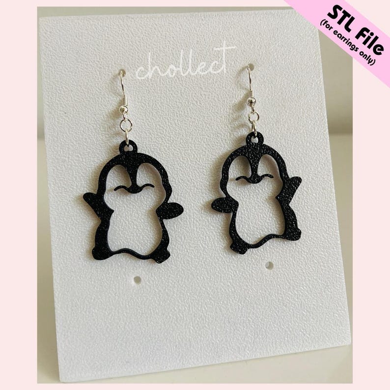 May include: Black penguin-shaped earrings with silver hooks. The earrings are cut out, showing the penguin's outline. They are displayed on a white card with the word "chollect" printed on it. The text "STL File (for earrings only)" is in the upper right corner.