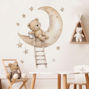 May include: A brown teddy bear sitting on a crescent moon with a ladder leading up to it. The moon and stars are beige and brown. The background is a white wall.