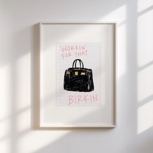 May include: A white framed print with a black and white illustration of a Birkin bag on a lined paper background. The text "Workin' for that Birkin" is written in pink.