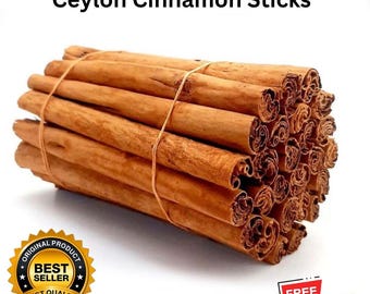 Puede incluir: Un paquete de palitos de canela de Ceilán, atados con hilo. Los palitos son de color marrón cálido, con un aspecto enrollado. El texto en la parte superior dice "Ceylon Cinnamon Sticks". Un sello dorado con "Best Seller" está en la parte inferior izquierda.