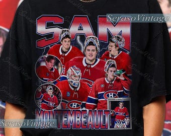 May include: Black t-shirt featuring a collage of images of a hockey player in a red and blue uniform. The name "SAM" is printed in large red letters, with "MONTEMBEAULT" below. The shirt has a vintage style.