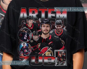 May include: Black t-shirt featuring a graphic of Artem Zub, a hockey player, with the text "ARTEM ZUB" in red and white. The design includes multiple images of the player in his hockey uniform. The shirt has a vintage aesthetic.