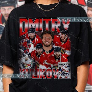 May include: Black t-shirt featuring a collage of hockey player Dmitry Kulikov in a red and black uniform. The shirt includes the name "Dmitry Kulikov" in a red and white retro font, with additional images of the player.